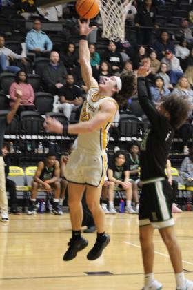 Tecumseh's Macen McKiddy puts one through the hoop after catching a pass from Jackson Martin in the second quarter of the Class 4A Distirct game against Harding Charter on Feb. 16. The Savages won, 75-74, and will play in Regional competition today (Feb. 22) in Douglass, along with the Lady Savages who also won Districts. Countywide &amp; Sun/Natasha Dunagan