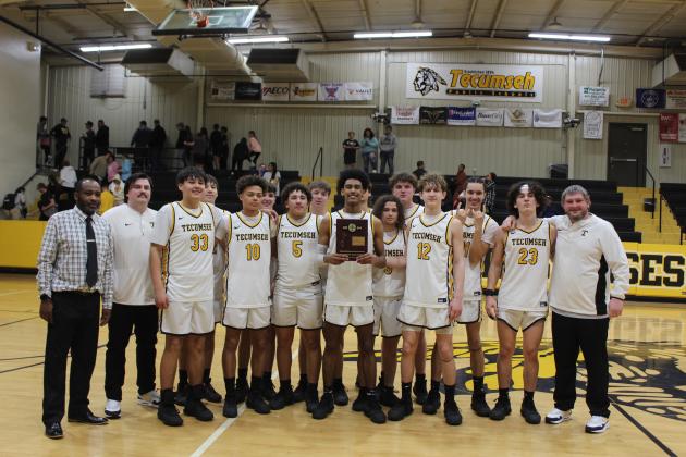 The Tecumseh High School Savages, along with Head Coach Bryant Edwards, far left, and assistant coaches pose after winning the Class 4A District game against Harding Charter on Feb. 16. They will play in Regionals at Douglass today (Feb. 22) at 7:30 pm. The Lady Savages also won their District game, and will play in Regionals at 6 pm. Countywide  &amp; Sun/Natasha Dunagan