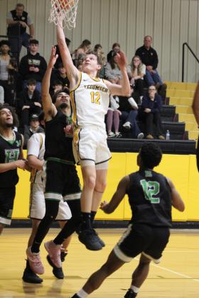 Tecumseh's Kohen Warden puts in a layup during the Class 4A Distirct game against Harding Charter on Feb. 16. The Savages won, 75-74, and will play in Regional competition today (Feb. 22) in Douglass, along with the Lady Savages who also won Districts. Countywide &amp; Sun/Natasha Dunagan