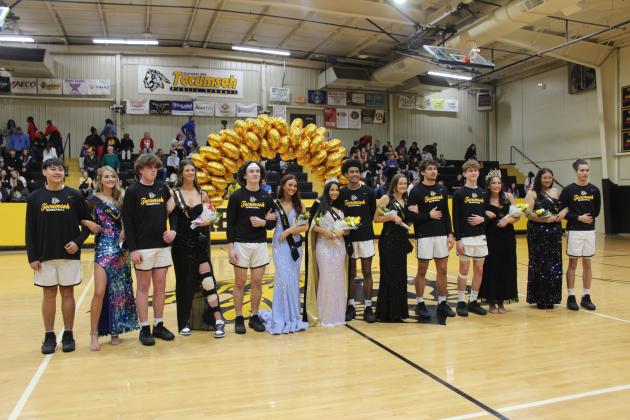 Escorted by basketball players, the Tecumseh Spring Homecoming attendants and queen candidates pose with the 2024 Queen Jadyn Wilson, center, and 2023 Queen Blakeley Sanchez following the coronation on Jan. 26. Countywide &amp; Sun/Natasha Dunagan
