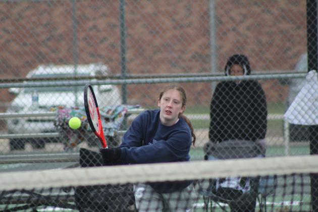 Shawnee junior Emma Hitt, on the #2 Doubles team, makes a return during the Shawnee High School Tennis Tournament on March 15. There were eight schools playing that day, with the boys playing at SHS and the girls at OBU.