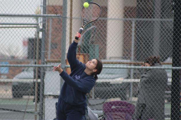 Shawnee junior Izzy Johnson, on the #2 Doubles team, serves against Stillwater during the Shawnee High School Tennis Tournament on March 15. There were eight schools playing that day, with the boys playing at SHS and the girls at OBU. Shawnee Boys Tennis Coach Dacia Jordan said this is the third time for their home courts to be used since the fences were replaced recently, after the April 2023 tornado damage.