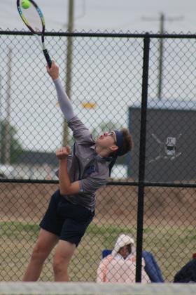Shawnee sophomore Carter Schollenbarger serves during the Shawnee High School Tennis Tournament on March 15. There were eight schools playing that day, with the boys playing at SHS and the girls at OBU. Shawnee Boys Tennis Coach Dacia Jordan said this is the third time for their home courts to be used since the fences were replaced recently, after the April 2023 tornado damage. Jordan said whether they replace their building will depend on if the April 2 school bond passes. Countywide &amp; Sun/Natasha Dunagan
