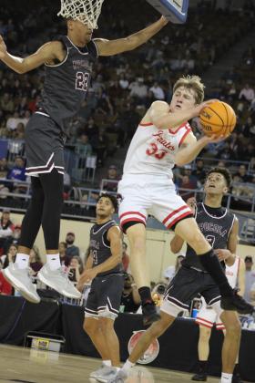 Dale senior Dayton Forsythe makes a jump pass, faking out the Pocola defender, during the Class 2A State Tournament Finals, held at the State Fair Arena on March 9. The Pirates are State Champs for the third year in a row. They beat Warner, 87-50; Hennessey, 67-44; and Pocola, 63-38, and they end the season with a record of 30-2. Countywide &amp; Sun/Natasha Dunagan
