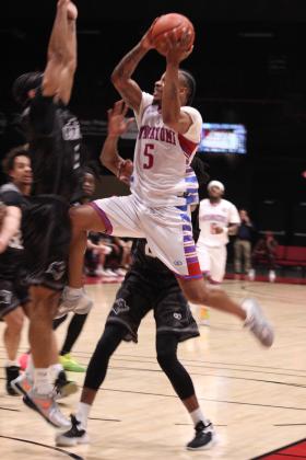 Potawatomi Fire power forward Ruston Hayward flies into the Enid Outlaws defense as he takes his shot during their first game of the third season on March 1. The Basketball League National Champions beat the Outlaws at FireLake Arena, 136-91. Countywide &amp; Sun/Natasha Dunagan