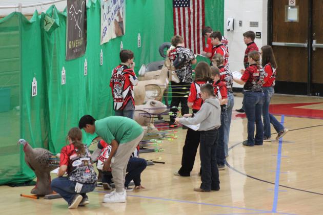 Archery students calculate their scores and retrieve their arrows during the 2024 Oklahoma State NASP®/IBO 3D Challenge, held at McLoud High School on March 2. Countywide &amp; Sun/Natasha Dunagan