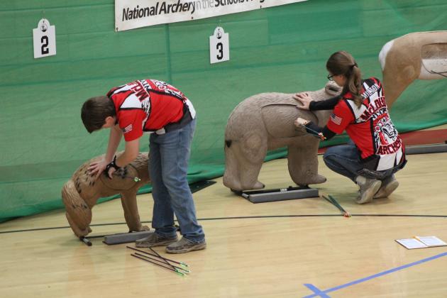 McLoud Middle School student Eric Brown and McLoud High School student Felicity Hamilton retrieve their arrows during the 2024 Oklahoma State NASP®/IBO 3D Challenge on March 2. Countywide &amp; Sun/Natasha Dunagan