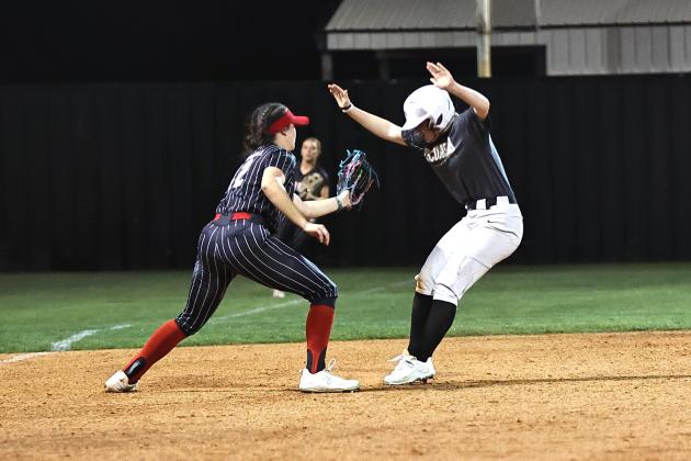 North Rock Creek's Sarah Campbell got the ball from centerfielder Molly Campbell, to tag the runner during action Monday, Mar. 11. Photo provided by Gowin Photography