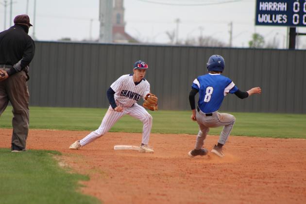 Shawnee sophomore Dominic Denega guards second base and tries to tag the Harrah runner during the home game on March 22. Countywide &amp; Sun/Natasha Dunagan
