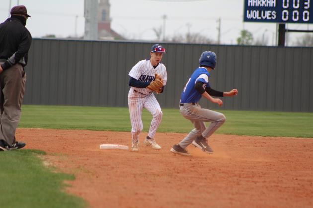 Shawnee sophomore Dominic Denega guards second base and tries to tag the Harrah runner during the home game on March 22. Countywide &amp; Sun/Natasha Dunagan