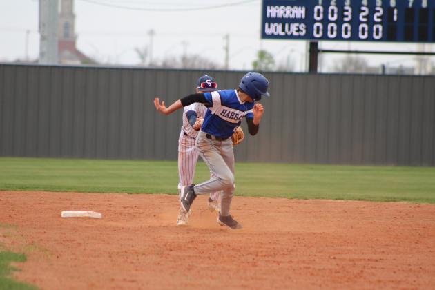 Shawnee sophomore Dominic Denega guards second base and tries to tag the Harrah runner during the home game on March 22. Countywide &amp; Sun/Natasha Dunagan