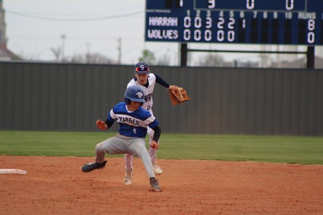 Shawnee sophomore Dominic Denega guards second base and tries to tag the Harrah runner during the home game on March 22. Countywide &amp; Sun/Natasha Dunagan