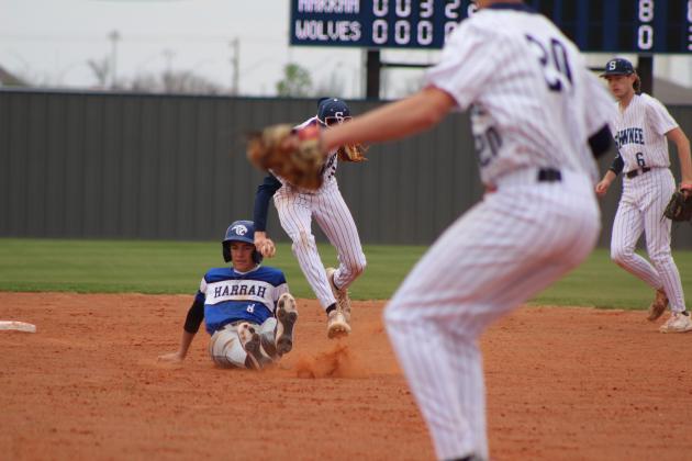 Shawnee sophomore Dominic Denega guards second base and tries to tag the Harrah runner during the home game on March 22. Countywide &amp; Sun/Natasha Dunagan