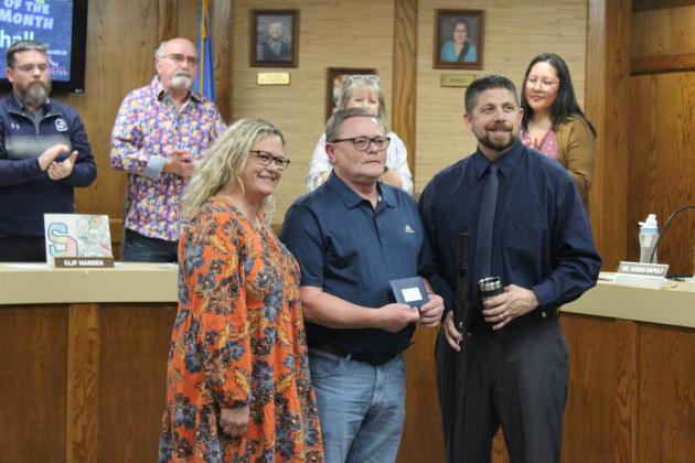 Shawnee Superintendent Dr. Aaron Espolt, far right, presents a $100 gift card, umbrella and tumbler to Shawnee Star of the Month Jefferson Elementary Teacher Paul Marshall, as Principal Jennifer Epperley looks on, during the March 4 Board of Education meeting. Countywide &amp; Sun/Natasha Dunagan