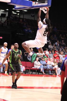 Potawatomi Fire small forward K.D. Moore puts up a slam dunk in the second quarter of the home game against the Little Rock Lightning. The Fire won, 125-105, making their record 11-0. Countywide &amp; Sun/Natasha Dunagan