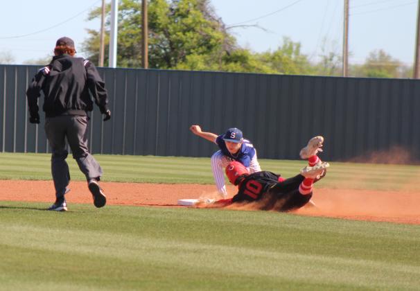 Shawnee sophomore Dominic Denega tags Dale's Braylon White as he dives into second during the Bill Tipton Classic game at Shawnee on April 11. The Dale Pirates won all four of their games, as well as the tournament. They beat Shawnee, 9-6; Eisenhower, 6-0; Piedmont, 7-3; and Elgin, 14-6, over three days. Countywide &amp; Sun/Natasha Dunagan