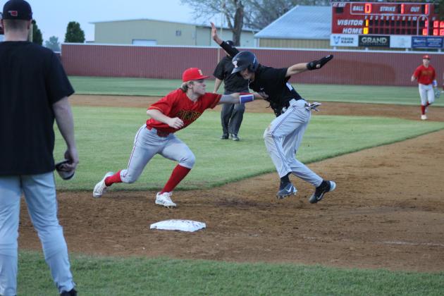 Dale senior Dayton Forsythe tags a Tuttle runner as he tries to go back to first base during the April 8 home game. The Pirates won, 6-2.