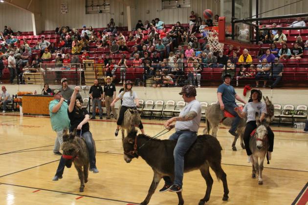 Amanda Elmore throws up a shot during the Donkey Basketball game at Earlsboro High School on April 9. The Town of Earlsboro fund-raiser featured two games: Earlsboro Police and Fire Departments vs. Earlsboro Teachers and the Mize Agency vs. Earlsboro students. They also raised money through a dessert drawing, silent auction and a pre-game dinner. Countywide &amp; Sun/Natasha Dunagan