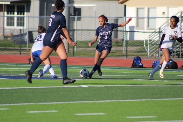 Shawnee's Breeauna Simpson (#3) dribbles the ball toward teammate Kalieo Citizen (#23) during the home game against Victory Christian on April 2. This was the first day for athletes to play on the new turf at Jim Thorpe Stadium. Countywide &amp; Sun/Natasha Dunagan
