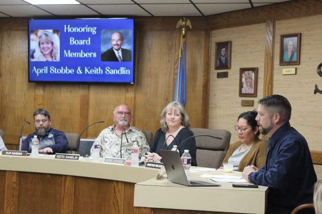 Shawnee Superintendent Dr. Aaron Espolt, far right, speaks about retiring Board of Education members Keith Sandlin and April Stobbe during their last meeting on April 1. Sandlin has served on the board for 24 years, and Stobbe has been serving for 22 years. They both received a clock plaque. Also shown are Board President Clif Harden, far left, and member Kristen Wilson. Countywide &amp; Sun/Natasha Dunagan