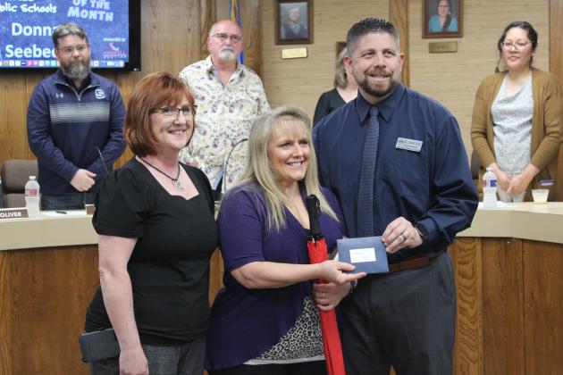 Shawnee Superintendent Dr. Aaron Espolt presents a gift card and umbrella to Will Rogers Elementary Cafeteria Manager Donna Seebeck, who was named the Shawnee Star of the Month on April 1. Also shown is Director of Nutrition Services Julie Jesseph. In the background is Shawnee Board of Education President Clif Harden, retiring board member Keith Sandlin and member Kristen Wilson. Countywide &amp; Sun/Natasha Dunagan