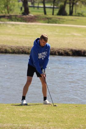 Bethel senior Jake Stephenson drives over a water hazard to the 10th hole at FireLake Golf Course during the Tecumseh Boys Golf Tournament on April 11. Countywide &amp; Sun/Natasha Dunagan