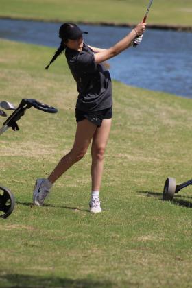 Tecumseh sophomore Isabelle Duggan drives across a water hazard during the Tecumseh Girls Golf Tournament on April 16. Countywide &amp; Sun/Natasha Dunagan