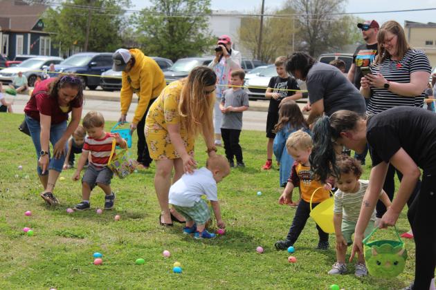 Parents point out plastic eggs to their two- and three-year-olds during the Tecumseh Citywide Easter EGGsperience on March 30, organized by the Tecumseh Assembly of God Church. There were 8,000 eggs to collect, prize drawings, inflatables, live music, hotdogs and drinks at the event. Countywide &amp; Sun/Natasha Dunagan