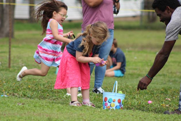 Emma Bernard, 4, of Tecumseh, can't wait to see what's inside the eggs, as another egg hunter runs past, during the Tecumseh Citywide Easter EGGsperience on March 30, organized by the Tecumseh Assembly of God Church. There were 8,000 eggs to collect, prize drawings, inflatables, live music, hotdogs and drinks at the event. Countywide &amp; Sun/Natasha Dunagan