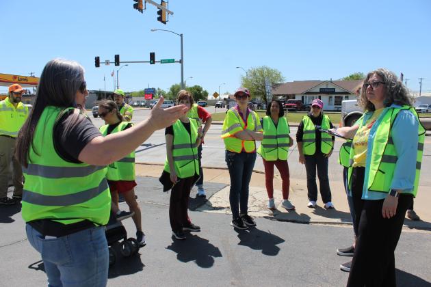 Tecumseh Chamber of Commerce Executive Director Kimberly Elliott, far left, rates her experience walking east on Walnut Street during the Tecumseh Walking Audit on April 12. It was led by Holly Gordon, from the TSET Healthy Living Program, far right, who asked everyone for a rating every few blocks. Countywide &amp; Sun/Natasha Dunagan