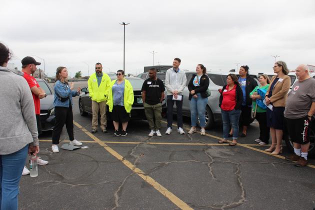 United Way of Pottawatomie County Disaster Recovery Coordinator Laura Barrow speaks with volunteers who met in the Big Lots parking lot before dividing into groups and going into Shawnee neighborhoods to deliver resource information bags on April 15. Countywide &amp; Sun/Natasha Dunagan