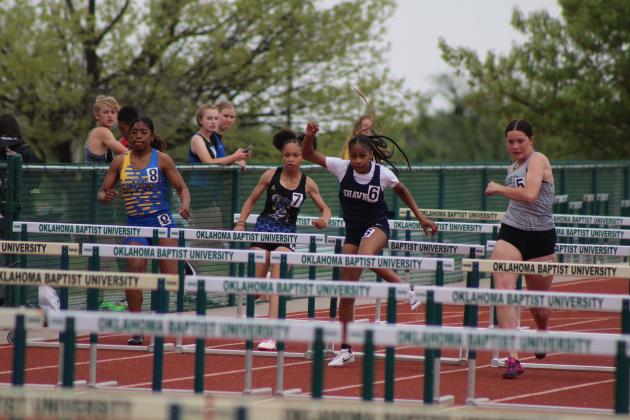 Shawnee's Deoncesay Beavers, third from left, clears a hurdle during the track and field meet held at OBU on April 9. Countywide &amp; Sun/Natasha Dunagan