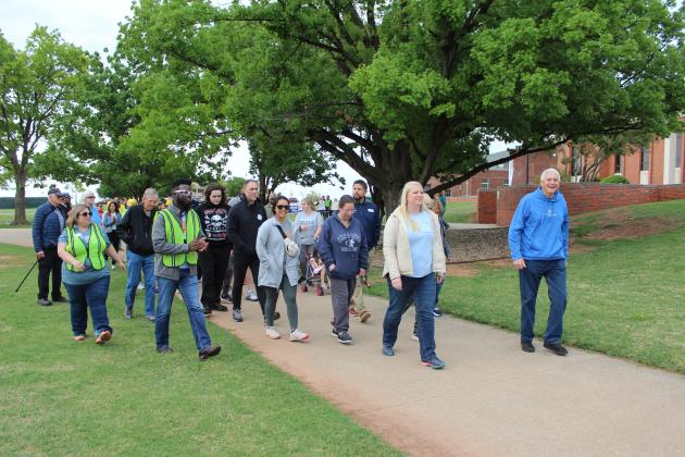 About 75 people participated in the United in Strength Stroll on April 19, recognizing the one-year anniversary of the 2023 tornado. Following a proclamation by Shawnee Mayor Ed Bolt (far right) and speeches from John Bobb-Semple, of POGO; Heath Thomas, of OBU; Dr. Aaron Espolt, of Shawnee Public Schools; and Sandy Vanderburg, of United Way of Pottawatomie County (second from right), they walked from OBU to the YMCA. Countywide &amp; Sun/Natasha Dunagan