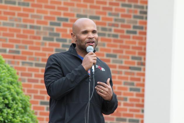 John Bobb-Semple, from Pottwatomie Go, speaks from the front porch of the Geiger Center at Oklahoma Baptist University during the United in Strength Stroll on April 19. Several other community leaders also spoke before they led a group in the one-mile walk to the YMCA. Countywide &amp; Sun/Natasha Dunagan