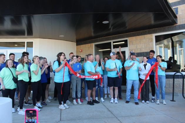 Everyone applauds as Shawnee YMCA CEO Mike Jobe cuts the ribbon, with the help of board members, employees, and others, to officially reopen the Troy and Dollie Smith Family YMCA on April 6, almost a year after it was hit by the April 19, 2023 tornado. Jobe later said approximately 1,800 people attended the Grand Reopening party. Countywide & Sun/Natasha Dunagan