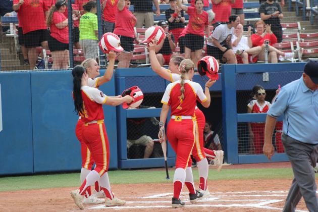 Dale Lady Pirates teammates hit helmets after Makenzie Ellis, behind #1, hit a home run in the first inning of the Class 4A Slow Pitch State Championship on April 30. That day, they beat Stroud, 15-1, and Latta, 14-5, but fell to the #4-ranked Silo, 4-14. The Lady Pirates end their season as the Class 4A State Runners-Up, with a record of 33-9.  Countywide &amp; Sun/Natasha Dunagan