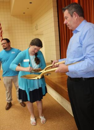 Tecumseh Head Librarian Beth Lyle signs one of two shovels during the Dobson Fiber Groundbreaking Ceremony at Tecumseh City Hall Auditorium on May 16. The shovels are held by Chief Strategy Officer Jim Horsburgh and will be hung in their OKC office. Dobson Fiber will offer residential fiber internet once their lines have been laid throughout Tecumseh neighborhoods, in a couple of months, said Director of Marketing Ali Clark. Countywide &amp; Sun/Natasha Dunagan