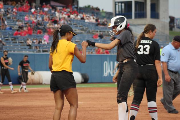 Senior Serenity Jacoway gets a fist bump from Assistant Coach Kayla Rodriguez after hitting a single.