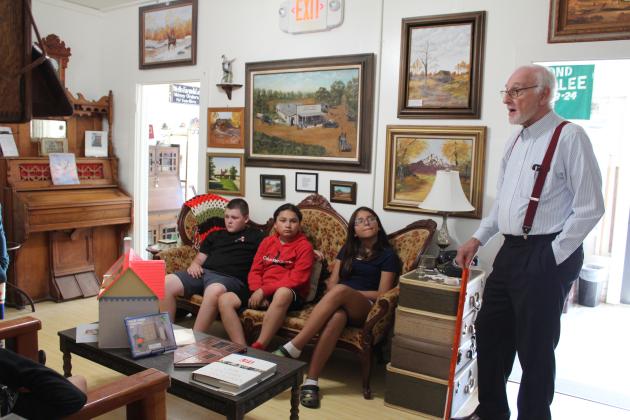 Randy Swinson, a volunteer at the Tecumseh Historical Society Museum, tells students in Colby Waller's class about the evolution of the telephone.