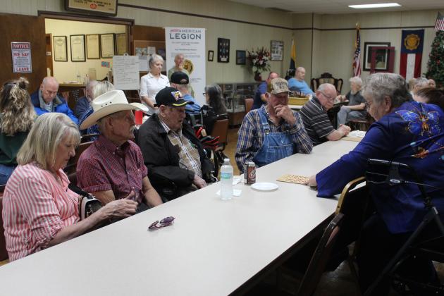 American Legion Post #260 Auxiliary President Donna Snodgrass, far right, checks a bingo for Fred Souders, as his family members look on, at the Tecumseh post on May 9. From left are Souders' daughter Retha, son Lindel, Souders, and brother Merle Souders. Souders comes from the Norman Veterans Center for bingo every month and gets to visit with family, as well. Recreation Coordinator Darold Lairson said they have been bringing the veterans to play bingo for at least 30 years.