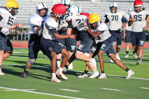 Members of the Shawnee High School Football Team play against each other and practice taking down the ball carrier during the Spring Game fundraiser on May 18, when they got to play on the new turf at Jim Thorpe Stadium for the first time. The entry fee was donations of laundry soap, bottled water, sports drinks or packaged snacks. Countywide &amp; Sun/Natasha Dunagan