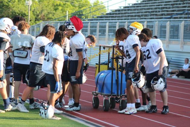 Players on the Shawnee High School Wolves Football Team get a drink during the Spring Game fundraiser on May 18, when they got to play on the new turf at Jim Thorpe Stadium for the first time. The entry fee was donations of laundry soap, bottled water, sports drinks or packaged snacks. Countywide &amp; Sun/Natasha Dunagan