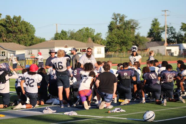 Head Coach Jason Madonna talks with the Shawnee High School Wolves football team following the Spring Game fundraiser on May 18. The entry fee was donations of laundry soap, bottled water, sports drinks or packaged snacks. Countywide &amp; Sun/Natasha Dunagan