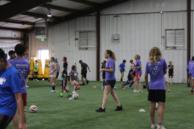 Two-time US Olympic Gold-medalist and U.S. Women’s Soccer Legend Lindsay Tarpley gives demonstration to a crowd of kids.