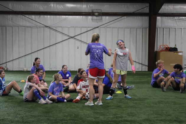 Two-time US Olympic Gold-medalist and U.S. Women’s Soccer Legend Lindsay Tarpley gives demonstration to a crowd of kids.
