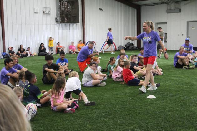 Two-time US Olympic Gold-medalist and U.S. Women’s Soccer Legend Lindsay Tarpley gives demonstration to a crowd of kids.