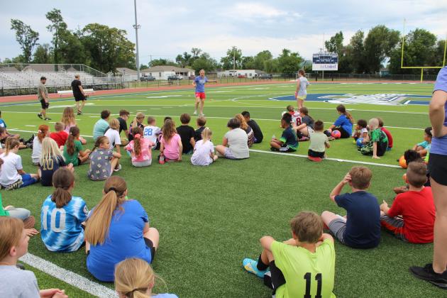 Two-time US Olympic Gold-medalist and U.S. Women’s Soccer Legend Lindsay Tarpley gives demonstration to a crowd of kids.
