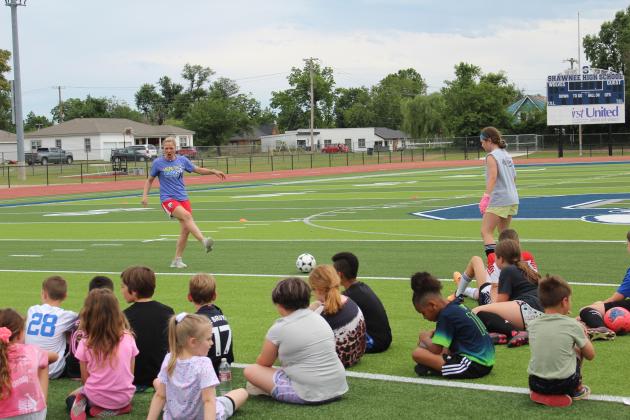 Two-time US Olympic Gold-medalist and U.S. Women’s Soccer Legend Lindsay Tarpley gives demonstration to a crowd of kids.
