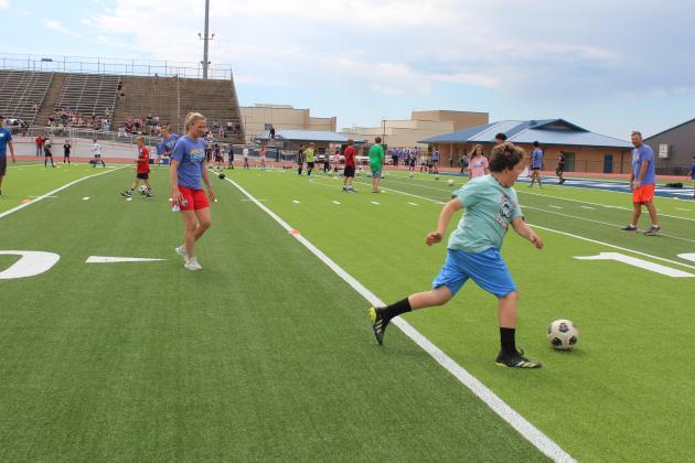 Two-time US Olympic Gold-medalist and U.S. Women’s Soccer Legend Lindsay Tarpley gives demonstration to a crowd of kids.