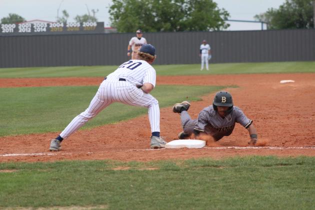 Shawnee freshman Rhett Hokit makes the catch and tries to tag the Midwest City runner, who dives. back to first, during the home game on April 25. The Wolves lost, 1-8. Countywide &amp; Sun/Natasha Dunagan